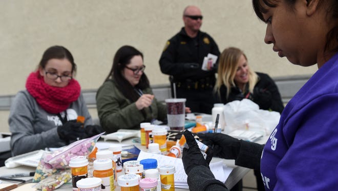 Volunteers sort and take note of pills during the twice annual Prescription Drug Round Up at the Save Mart on Kietzke in Reno on April 30, 2016.