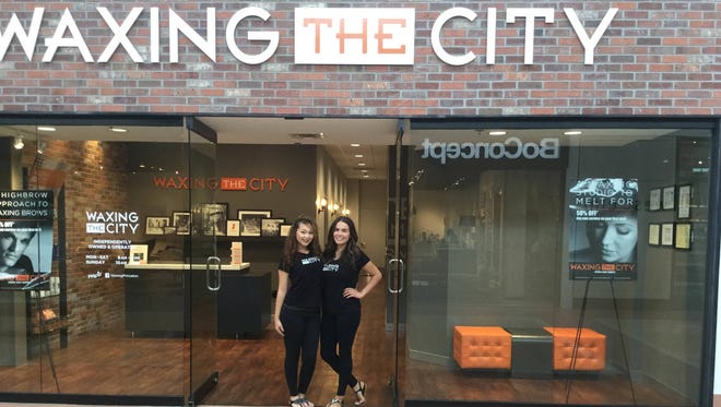 Waxing the City recently opened a location in Princeton at MarketFair Mall. Pictured from left to right are cerelogists Lydia Rios and Michelle Camp.