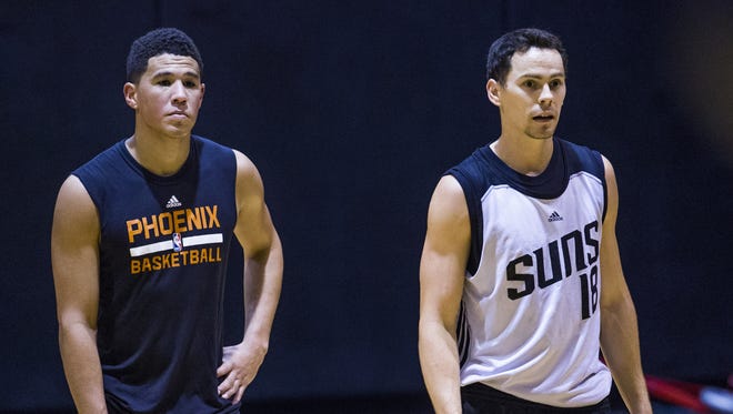 Devin Booker, left, and Kyle Kuric walk the court during Phoenix Suns Summer League at Talking Stick Resort Arena in Phoenix, Friday, July 8, 2016.