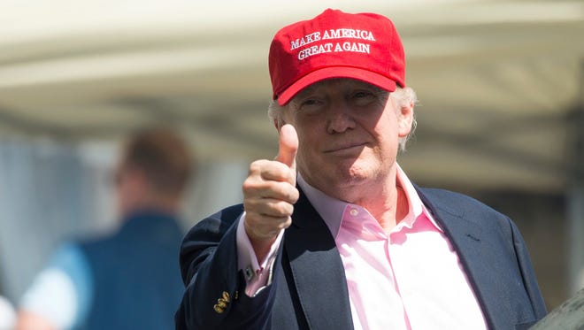 President Donald Trump gives a thumbs-up well wishers as he arrives at the 72nd U.S. Women's Open Golf Championship at Trump National Golf Course in Bedminster, New Jersey, July 16, 2017.