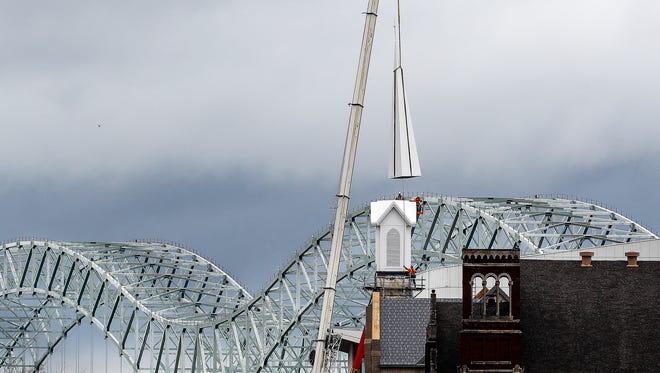Construction workers raise a new steeple onto First United Methodist Church's new sanctuary, which is under construction at Poplar and Second. The steeple raising marks a significant step in the Downtown church's comeback from a devastating 2006 fire.