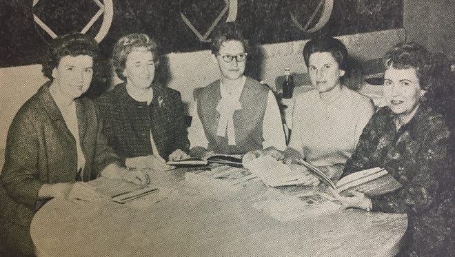 Members of the Union County Soil Conservation District Ladies Auxiliary examine some of the reference materials for the school libraries in November of 1965. They are (left to right) Lucille Rich, Katherine Sprague, Charlotte O'Nan, Irene Anderson, and Annie McElroy.