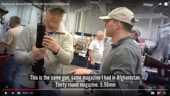 Dan Helmer, right, a Democratic candidate for the Virginia 10th District Congressional race, in a video still from a campaign video of him buying an AR-15 style rifle at a local gun show in a private sale. This type of transaction is legal under Virginia and Federal law. MUST CREDIT: Handout courtesy of Dan Helmer for Congress