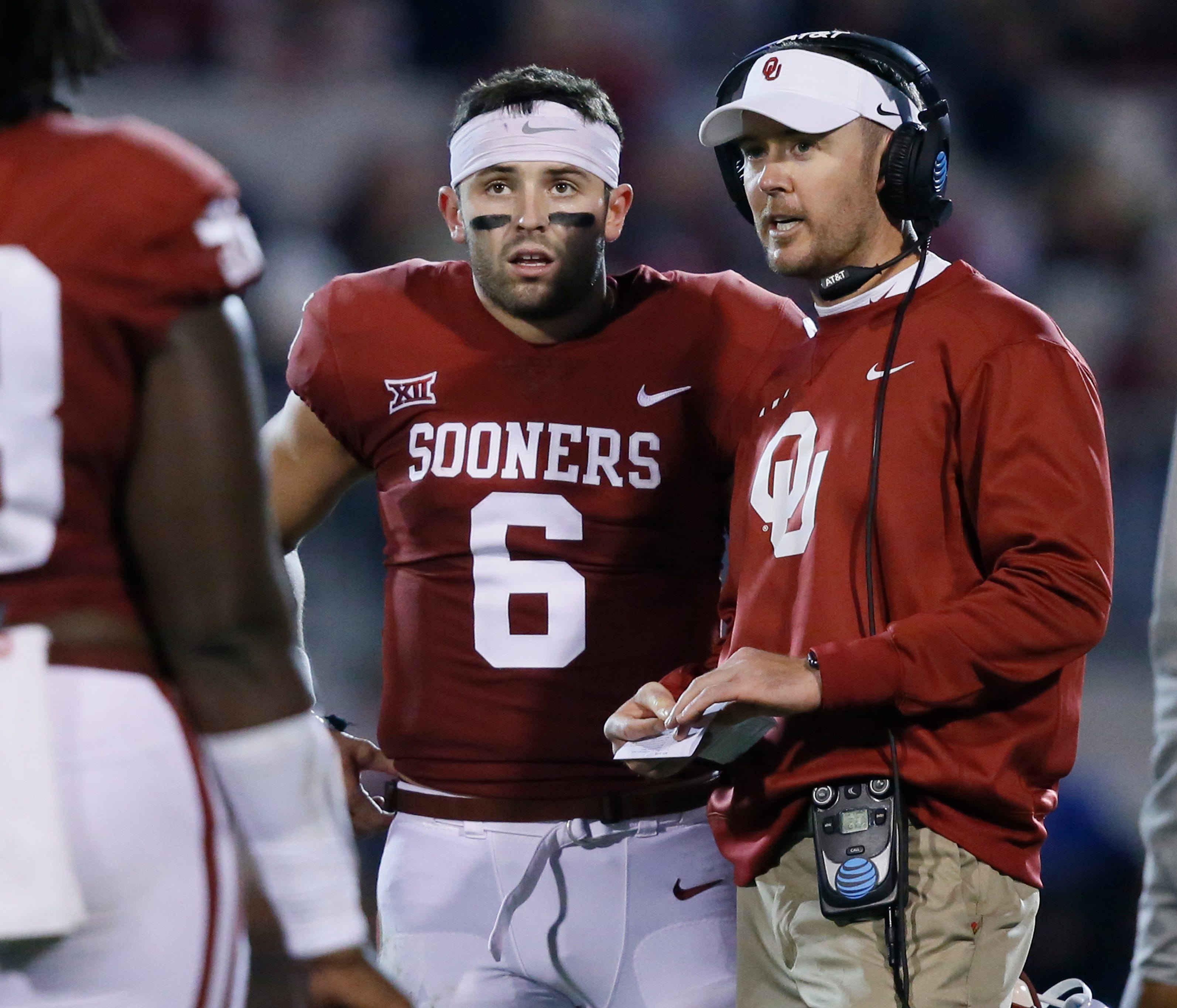 Oklahoma quarterback Baker Mayfield talks with coach Lincoln Riley during their game against TCU.