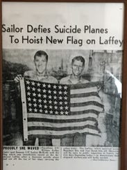 Bill Kelly (left) holds the Laffey's tattered American