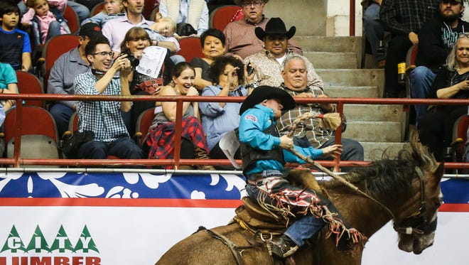 The crowd reacts as Jacobs Crawley rides a bronc during the 4th performance of the 85th annual San Angelo Stock Show & Rodeo Sunday, Feb. 5, 2017, at Foster Communication Coliseum.