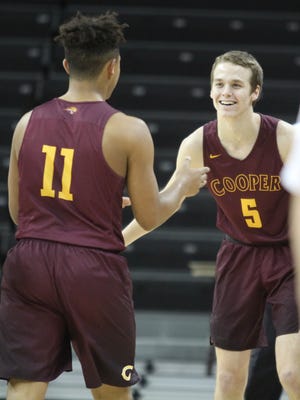 Cooper's Adam Kunkel congratulates Braydon Runion after Runion hit his third 3-pointer of the first period.