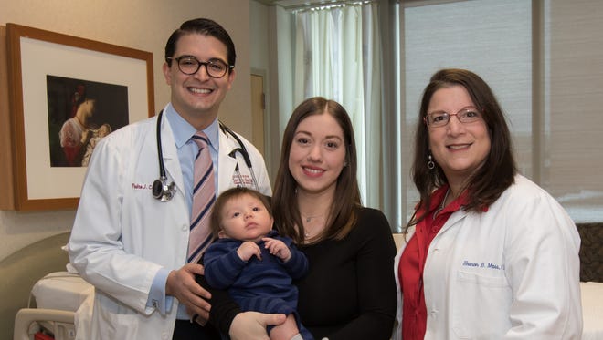 Third-year medical student Pedro Colon Ortiz with his wife, Andreas, and his newborn son, Stamatis,  with OBGYN Dr. Sharon Mass at Morristown Medical Center. Mass oversaw Colon Ortiz deliver the boy on Oct. 24, 2018. Weeks earlier, the couple had fled hurricane devastation in Puerto Rico. During their stay in the U.S., Colon Ortiz was able to complete a 12-week internal medicine rotation at the hospital.