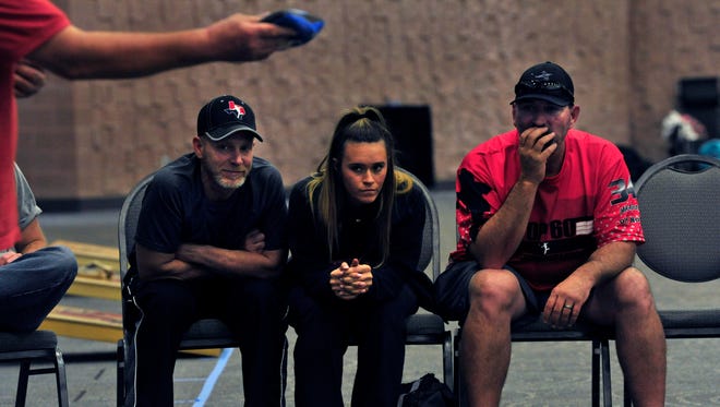 Troy Lobdell, of Decatur, Mika Murray and her father Mike Murray from Fort Worth, watch the action during the Texas Cornhole League Signature Series tournament at the Abilene Convention Center Saturday. About 150 people came from around the state for the event.