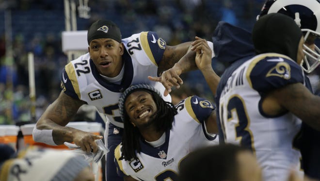 Los Angeles Rams players Trumaine Johnson (22) and Todd Gurley (30) celebrate on the bench during the second half.