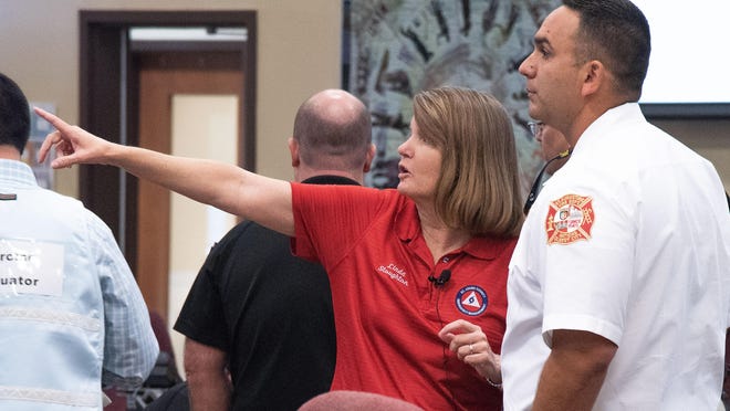 Linda Stoughton, St. Johns County director of emergency management, talks with St. Augustine Fire Chief Carlos Aviles during a hurricane preparation in St. Johns County's Emergency Operations Center in 2018.
