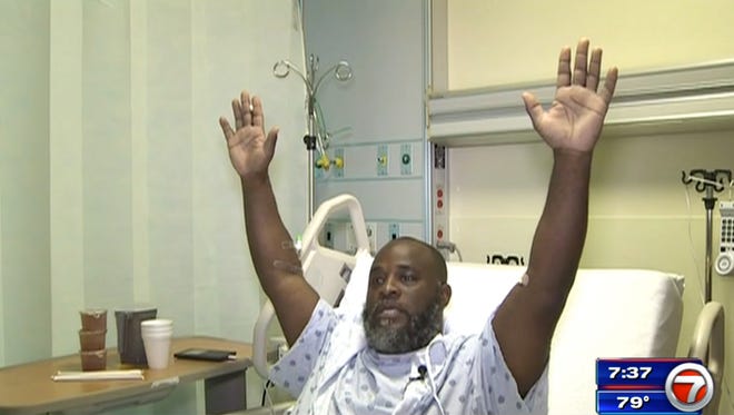 In this Wednesday, July 20, 2016, frame from video, Charles Kinsey explains in an interview from his hospital bed in Miami what happened when he was shot by police on Monday. Kinsey, a therapist who was trying to calm an autistic patient in the middle of the street, said he was shot even though he had his hands in the air and repeatedly told the police that no one was armed. (WSVN via AP)