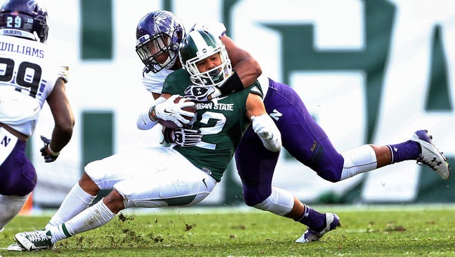 Oct 15, 2016; East Lansing, MI, USA; Michigan State Spartans receiver R.J. Shelton is tackled by Northwestern linebacker Joseph Jones during the first half at Spartan Stadium.