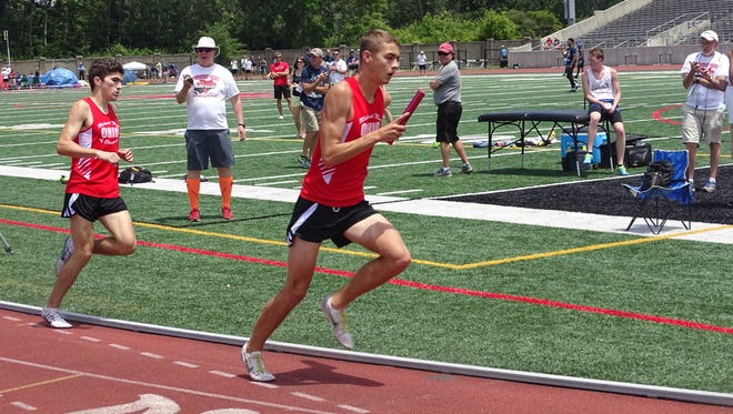 Lancaster's Andy Ferris takes off for the third leg of the 4x800 relay Saturday during the Midwest Meet of Champions at Ohio Wesleyan.