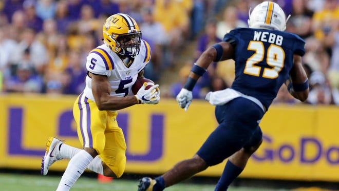LSU running back Derrius Guice (5) is pursued by Chattanooga defensive back Lucas Webb (29) during the first half of an NCAA college football game in Baton Rouge, La., Saturday, Sept. 9, 2017.