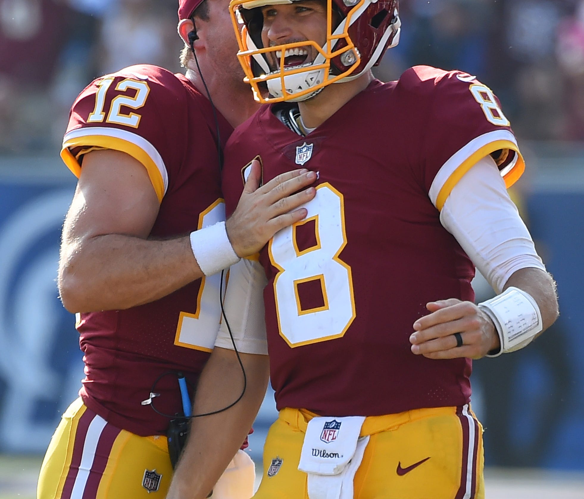 Washington Redskins quarterback Kirk Cousins (8) celebrates with Washington Redskins quarterback Colt McCoy (12) after throwing what turned out to be the game winning touchdown in the game against the Los Angeles Rams at the Los Angeles Memorial Coli