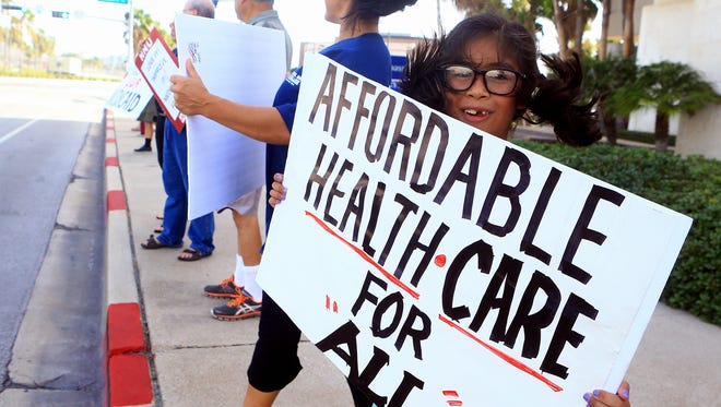 Protesters gather in front of Congressman Blake Farenthold office as they support others in the Medicare For All March on Monday, July 24, 2017, in Corpus Christi.