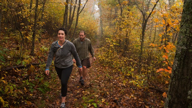 Chloe Hawkins, left, and Nathan Foley, both from Charlottesville, hike along Riprap trail in the Shenandoah National Park on Sunday, Oct. 12, 2014. "There were areas that were totally yellow, and red, the colors were totally fantastic," said Hawkins, describing the fall foliage.