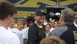 Michigan coach Jim Harbaugh meets high school players