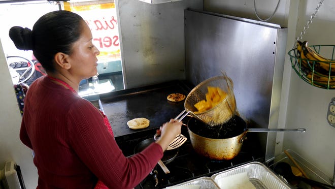 Gloria Gerber of Stuarts Draft makes El Salvandian dishes for the lunchtime crowd in their food truck, Gloria's Pupuseria, which she owns with her husband John. They were setup on Lewis Street in Staunton on Wed. March 2, 2016.