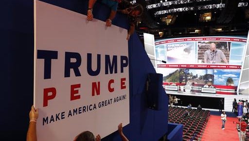 Workers place a sign as they prepare at Quicken Loans Arena for the Republican National Convention, Sunday, July 17, 2016, in Cleveland.