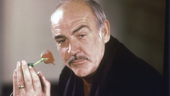 Actor Sean Connery holds a rose in his hand as he talks about his new movie "The Name of the Rose" at a news conference in London in 1987.