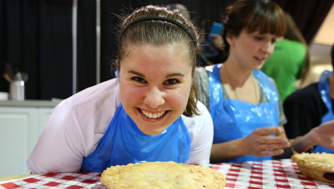 Statesman Journal reporter Kaellen Hessel competes in  the 2nd annual Willamette Valley Pie Company's pie-eating contest during 150th Oregon State Fair, Thursday, September 3, 2015, in Salem, Ore.
