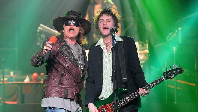 Singer Axl Rose (L) and bassist Tommy Stinson of Guns N' Roses perform at The Joint inside the Hard Rock Hotel & Casino during the opening night of the band's second residency, 'Guns N' Roses - An Evening of Destruction. No Trickery!' on May 21, 2014 in Las Vegas, Nevada.