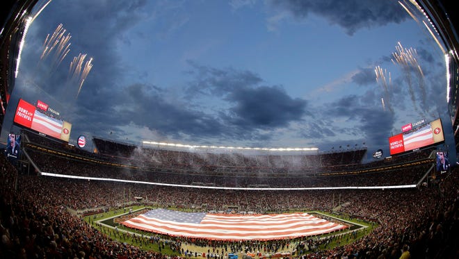 In this Sept. 14, 2015 photo taken with a fisheye lens, a large flag is presented during the national anthem at Levi's Stadium before an NFL football game between the San Francisco 49ers and the Minnesota Vikings in Santa Clara, Calif.
