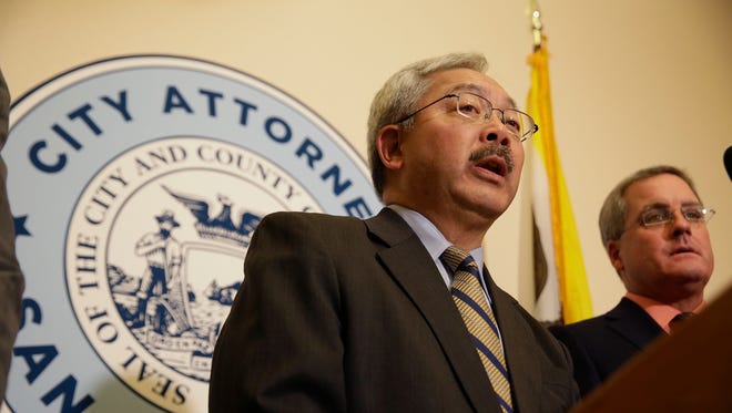 San Francisco Mayor Ed Lee, left, speaks during a news conference at City Hall Tuesday, Jan. 31, 2017, in San Francisco.