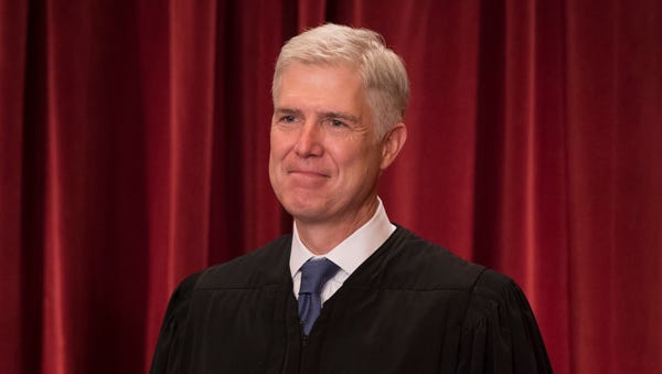 Associate Justice Neil Gorsuch poses for a group p