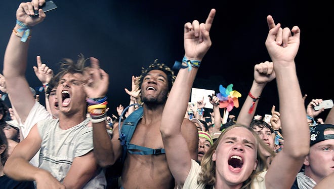 Fans cheer for Travis Scott as he performs on the final night of Bonnaroo on June 11, 2017.