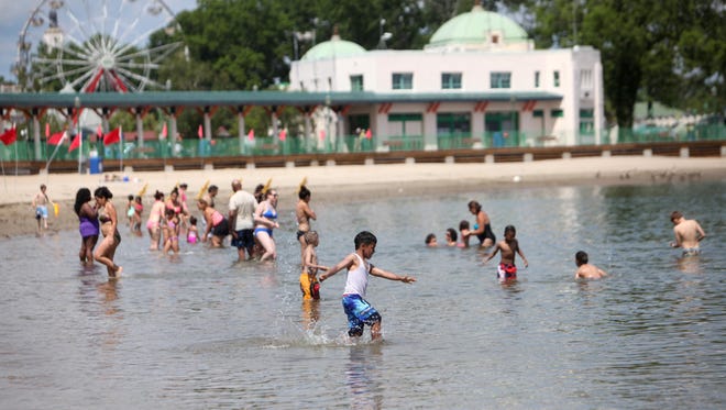 Beach-goers cool off in the water at Playland beach, June 27, 2014 in Rye.