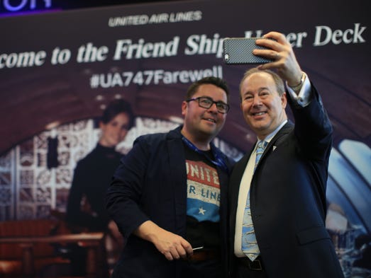 Passengers snap photos of themselves in front of a