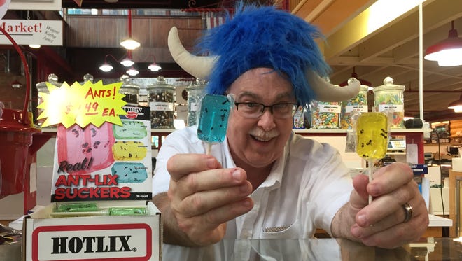 Wayne Carey, manager of Candy Rama inside the Lebanon Farmers Market, proudly displaying ANT-LIX Sucker lollipops.