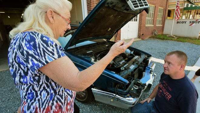 Dennis Tyndall of 1st Avenue Collision in Red Lion talks with Helen Mattox about fixing her car Friday, Aug. 19, 2016. Mattox' car was damaged by a hit-and-run driver, and Tyndall is repairing it for free. Bil Bowden photo