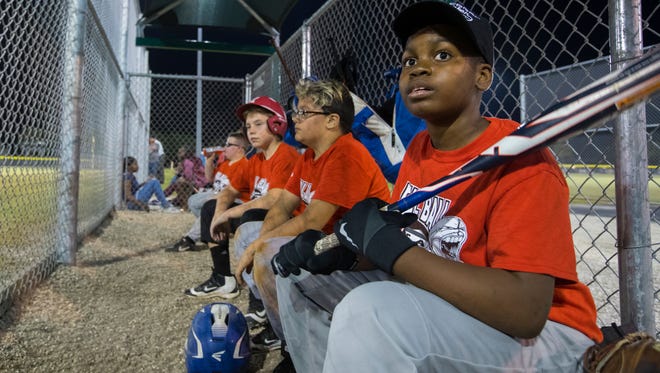 Ka’doffe Mathis, 12, waits for his turn to bat during a game at Pelican Baseball Complex in Cape Coral. Mathis, suffered a traumatic brain injury last October.
