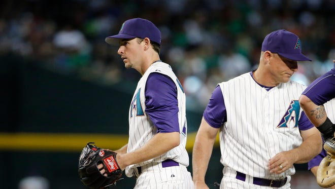 Diamondbacks manager Chip Hale pulls starting pitcher Allen Webster, left, from the game during the sixth inning of a baseball game Thursday, June 18, 2015, in Phoenix.