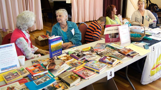 Volunteers from Literacy Link visit during the 2015 Community Outreach Day, hosted by the Silver City Woman's Club. The event returns this Saturday from 10 a.m. to 2 p.m. at the Woman's Club.