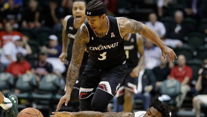 South Florida guard Geno Thorpe (13) reaches for the ball as Cincinnati guard Justin Jenifer (3) drives up the court during the second half of an NCAA college basketball game Wednesday, Feb. 15, 2017, in Tampa, Fla. Cincinnati won the game 68-54.