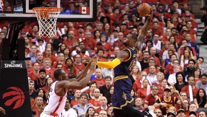 Cleveland Cavaliers forward LeBron James (23) goes up to dunk for a basket over Toronto Raptors center Bismack Biyombo (8) in the second quarter in Game 6 of the Eastern Conference Finals at Air Canada Centre.
