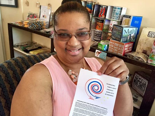 Rev. Ramona Kinard holds the logo for a dinner that