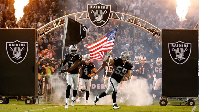 The Raiders run onto the field before a game in 2016. The team is moving to Las Vegas in 2020. Could it hold its training camp in Reno after the move?