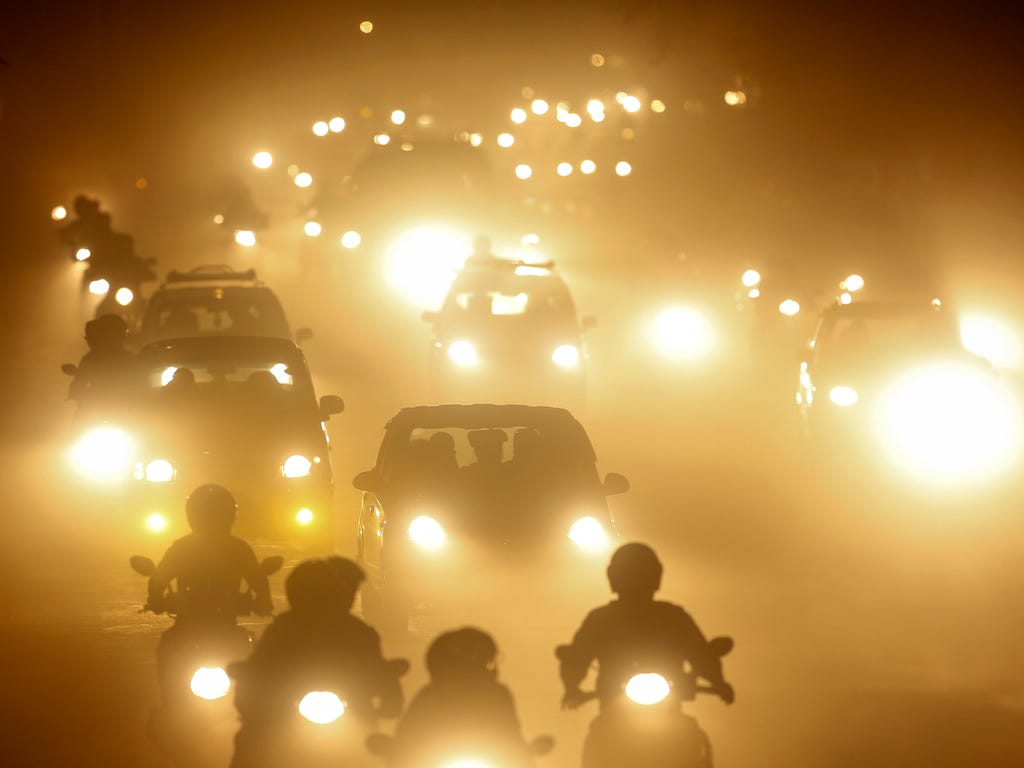 Vehicles run on a dusty road during the night in Kathmandu, Nepal. According to reports, road expansion, an increasing number of vehicles, the dumping of construction material on the sidewalks, and the rebuilding of the area following the April 2015 