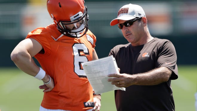 Cleveland Browns quarterbacks coach Ken Zampese, right, talks with quarterback Baker Mayfield at the NFL football team's training camp facility, Thursday, July 26, 2018, in Berea, Ohio. (AP Photo/Tony Dejak)