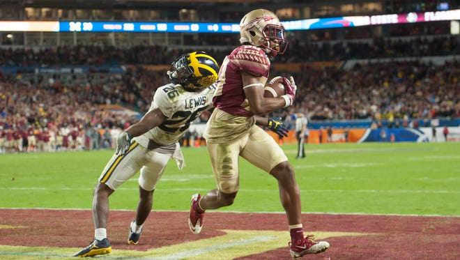 Florida State wide receiver Nyqwan Murray completes the winning touchdown catch ahead of Michigan cornerback Jourdan Lewis late in the fourth quarter during the Orange Bowl at Hard Rock Stadium in Miami Gardens, Florida, December 30, 2016.  Michigan lost to Florida State 33-32.