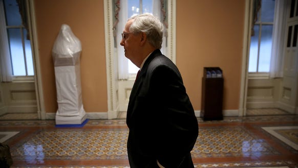Senate Majority Leader Mitch McConnell walks to his
