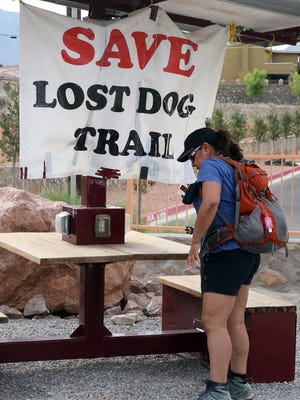Hiker Leticia Luna arrives at the Lost Dog Trailhead, which had a sign attached to a rest area in July 2018. Luna hikes the trails at least once per week.