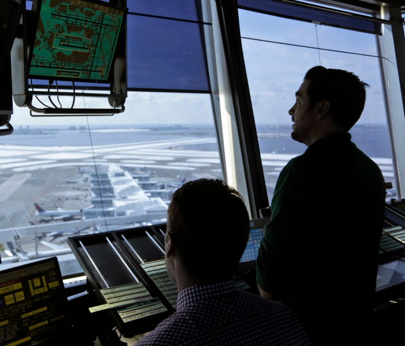 Air traffic controllers work March 16,2017, in the tower at John F. Kennedy International Airport in New York.