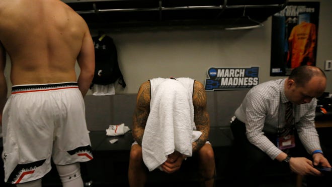 Cincinnati Bearcats guard Jarron Cumberland (34) hangs his head in the locker room after the NCAA Tournament Second Round game between the Cincinnati Bearcats and the Nevada Wolf Pack at Bridgestone Arena in Nashville on Sunday, March 18, 2018. The 2-seeded Bearcats were eliminated from the tournament by the Wolf Pack with a 75-73 loss.